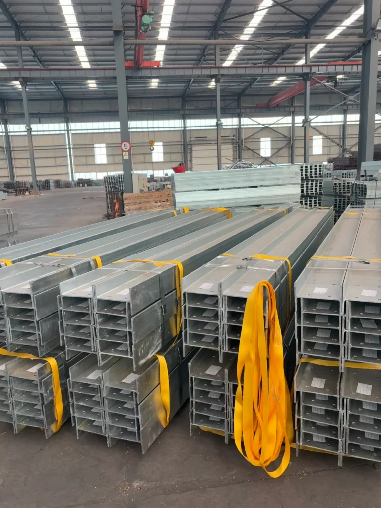 Bundled galvanised steel posts with yellow lifting straps