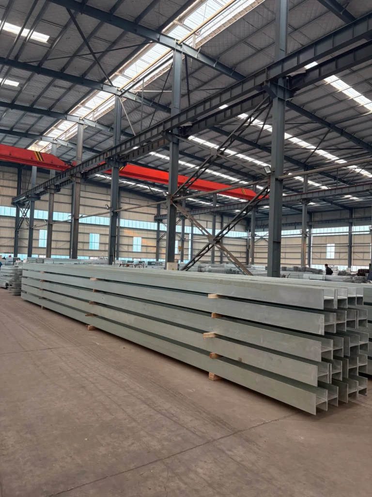 Long galvanised steel post sections stored in the warehouse